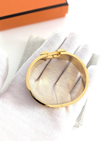 Hermes Clic Clac H bracelet in glacé brown/yellow gold