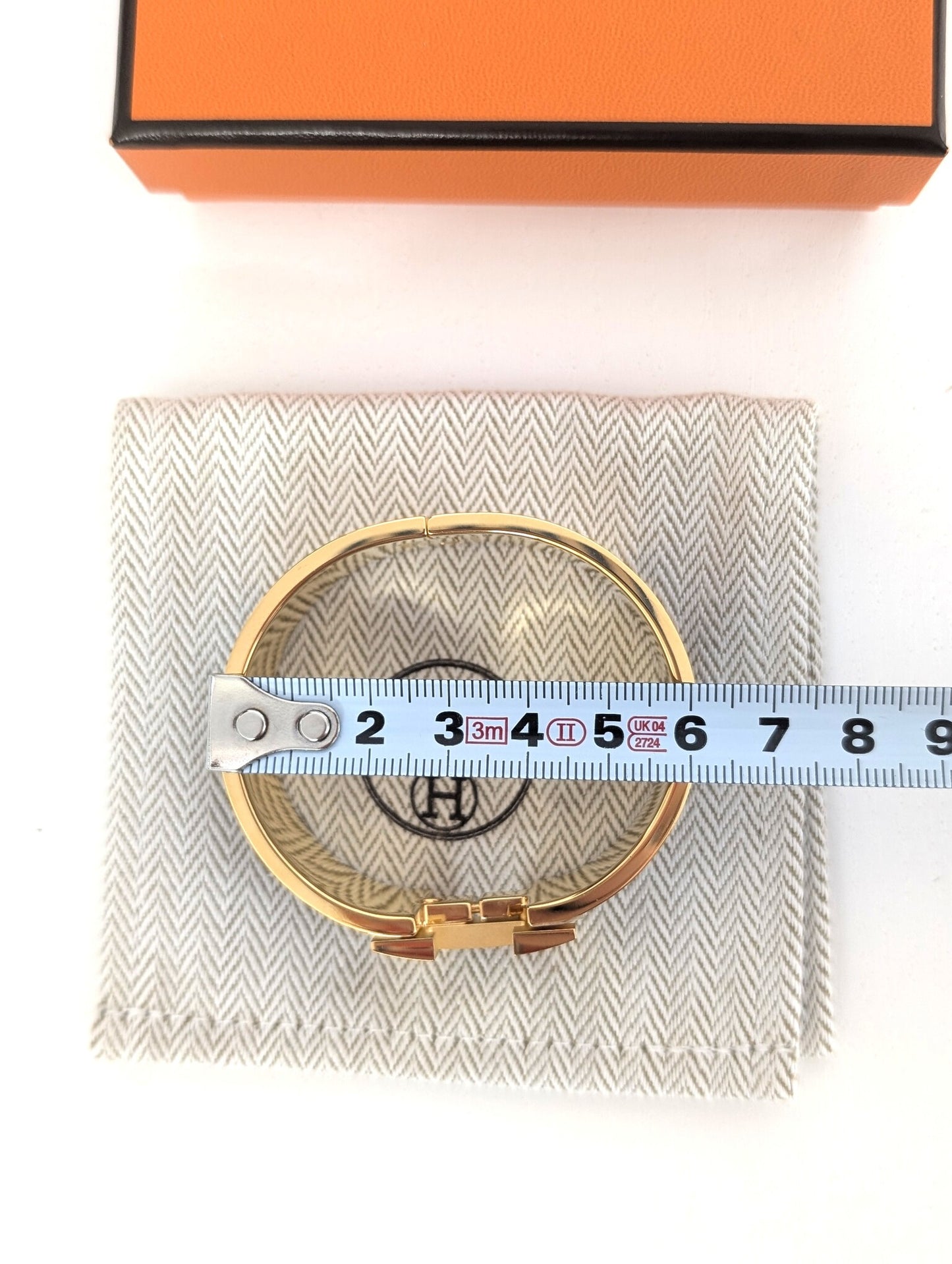 Hermes Clic Clac H bracelet in glacé brown/yellow gold