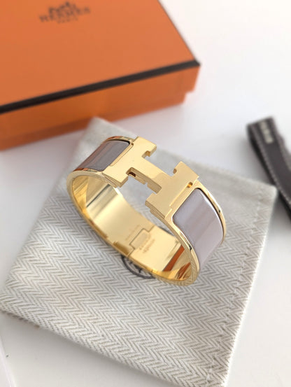 Hermes Clic Clac H bracelet in glacé brown/yellow gold